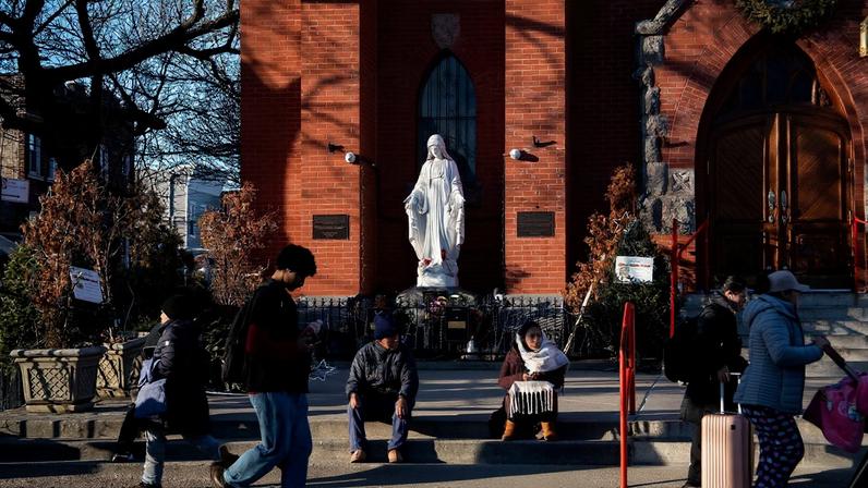 People gather outside Our Lady of Sorrows Catholic Church in the Corona neighborhood, a largely immigrant community, in the Queens borough of New York City, U.S., January 8, 2026. REUTERS/Dana Edwards