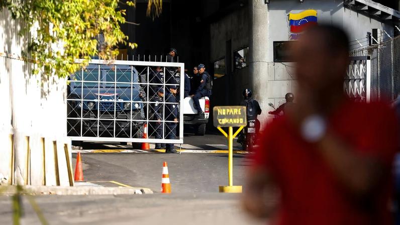 People stand next to a gate of the Bolivarian National Intelligence Service (SEBIN) headquarters, after National Assembly President Jorge Rodriguez announced that a number of foreign and Venezuelan prisoners will be released, in Caracas, Venezuela, January 9, 2026. REUTERS/Leonardo Fernandez Viloria