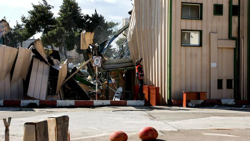 A man handles fallen cables at the Jerusalem headquarters of the United Nations Relief and Works Agency for Palestine Refugees (UNRWA) as the headquarters is dismantled by Israeli forces, in East Jerusalem, January 20, 2026. REUTERS/Ammar Awad