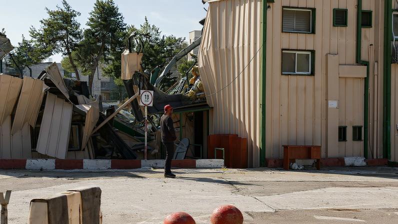 A man handles fallen cables at the Jerusalem headquarters of the United Nations Relief and Works Agency for Palestine Refugees (UNRWA) as the headquarters is dismantled by Israeli forces, in East Jerusalem, January 20, 2026. REUTERS/Ammar Awad