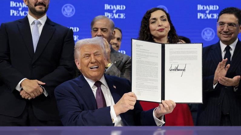 U.S. President Donald Trump takes part in a charter announcement for his Board of Peace initiative aimed at resolving global conflicts, alongside the 56th annual World Economic Forum (WEF), in Davos, Switzerland, January 22, 2026. REUTERS/Jonathan Ernst