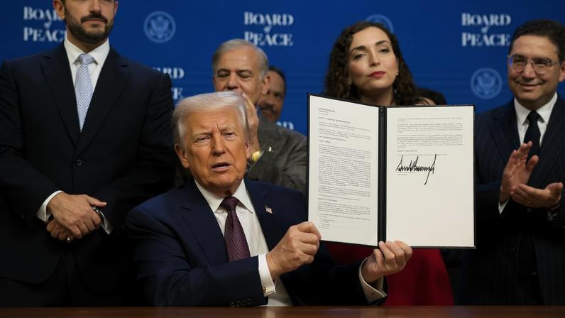 U.S. President Donald Trump takes part in a charter announcement for his Board of Peace initiative aimed at resolving global conflicts, alongside the 56th annual World Economic Forum (WEF), in Davos, Switzerland, January 22, 2026. REUTERS/Jonathan Ernst