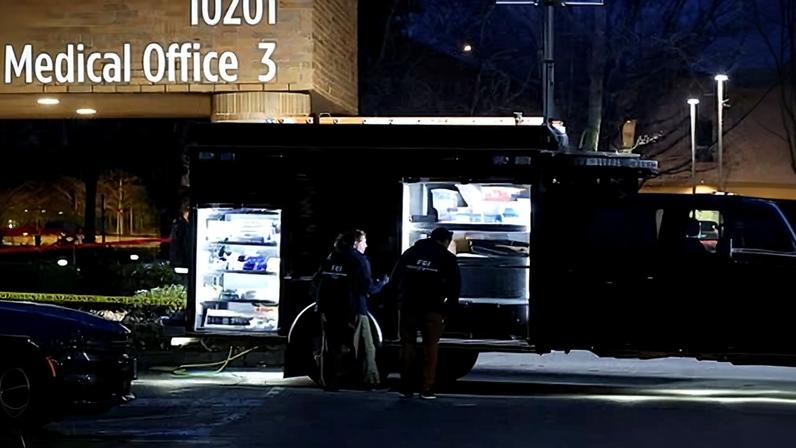 FBI agents work next to an evidence truck outside the Adventist hospital in Portland on Thursday.
