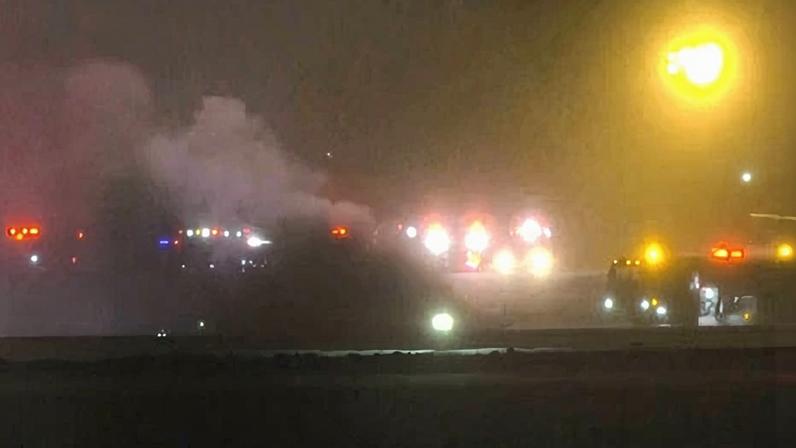 Emergency services work on the scene of the Bombardier Challenger 600 crash at the Bangor airport in Maine on 25 January 2026.