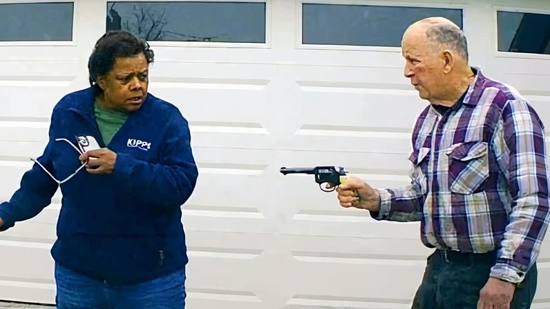 In this image taken from Uber dashcam video released by the Clark county sheriff's office, William Brock, right, holds a weapon to Uber driver Loletha Hall outside his home in South Charleston, Ohio, on March 25, 2024.