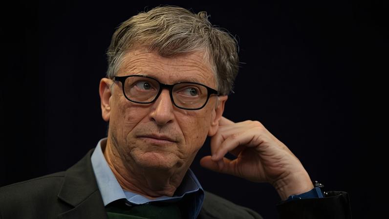 Bill Gates listens to a forum with his hand to his face at the 48th annual meeting of the World Economic Forum