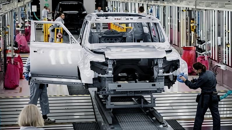 Workers polish the finish of a Land Rover Defender at the Jaguar Land Rover plant in Nitra, Slovakia
