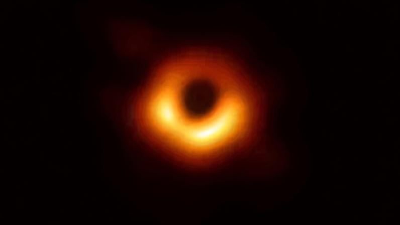 Dark round image surrounded by orange light