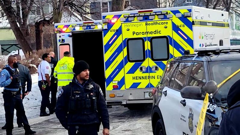 First responders perform CPR on a woman after she was shot in a vehicle by a U.S. immigration officer in Minneapolis