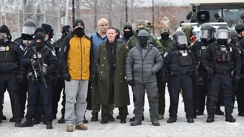 Gregory Bovino, center, stands flanked by fellow federal agents during a protest against ICE outside the Bishop Whipple Federal Building in Minneapolis on 15 January 2026.