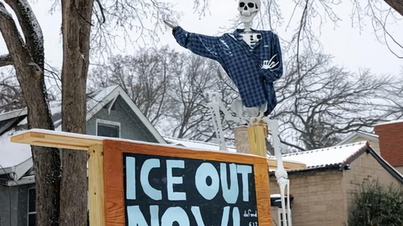 A skeleton decoration stands above a sign outside a home in Minneapolis, Minnesota, on Wednesday.