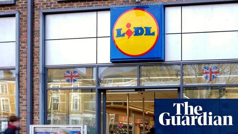 Shoppers walk past at a branch of Lidl in London.