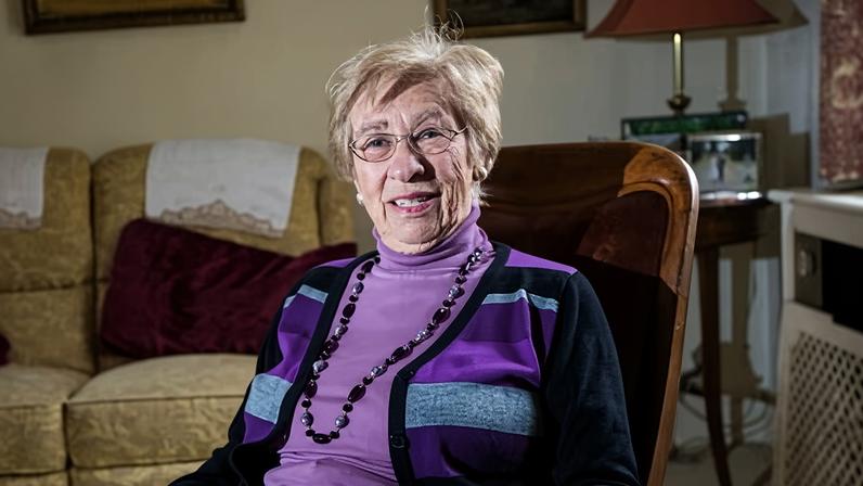 Holocaust survivor and stepsister of Anne Frank, Eva Schloss, sitting in an armchair