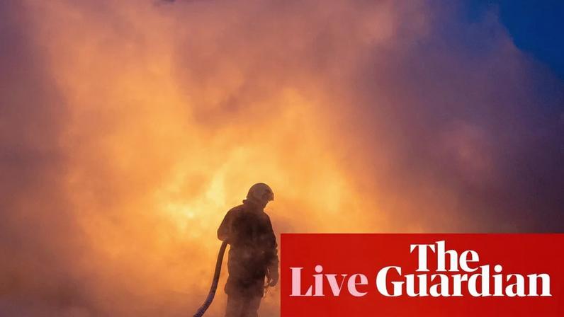 A Ukrainian emergency personnel works to extinguish a fire at the site of an air attack in Kyiv.