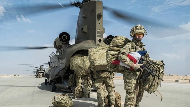 A British officer with the union flag under his arm at Camp Bastion, Helmand Province, Afghanistan in 2014.