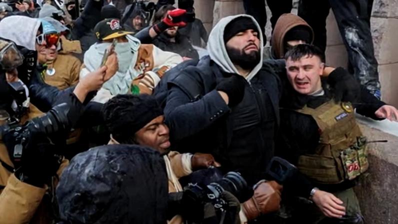 Jake Lang is physically confronted by a dense crowd of counter-demonstrators outside City Hall during an anti-Muslim and pro-ICE demonstration in Minneapolis, on Saturday.