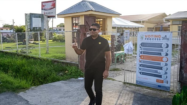 Azruddin Mohamed gestures to media after voting during the presidential election in Georgetown on 1 September 2025.