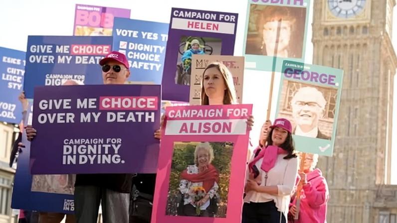 Assisted dying campaigners protest outside the Houses of Parliament in London.