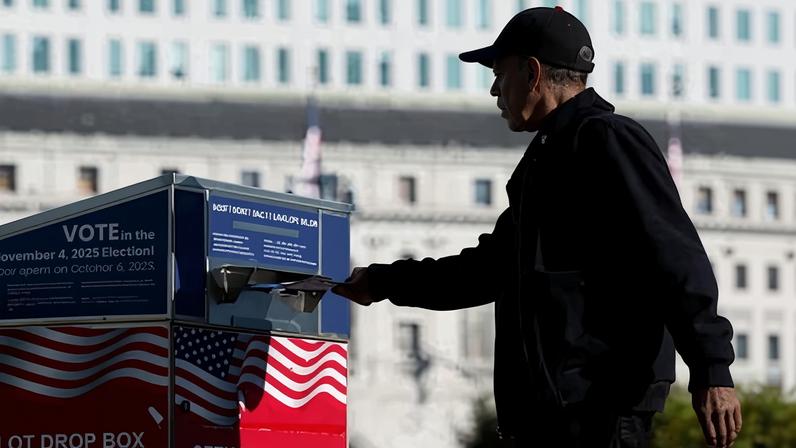 A voter drops his ballot in a drop box outside of San Francisco City Hall on 4 November 2025 for Prop 50 elections.
