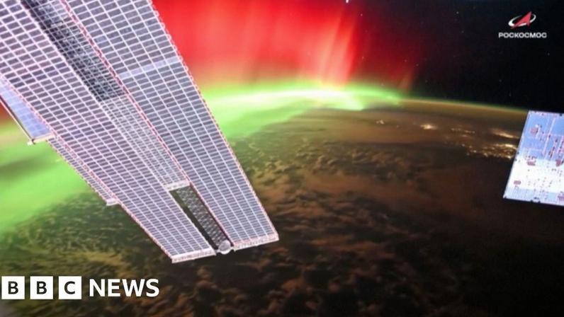 Aurora lights are seen around Earth's surface from the International Space Station.