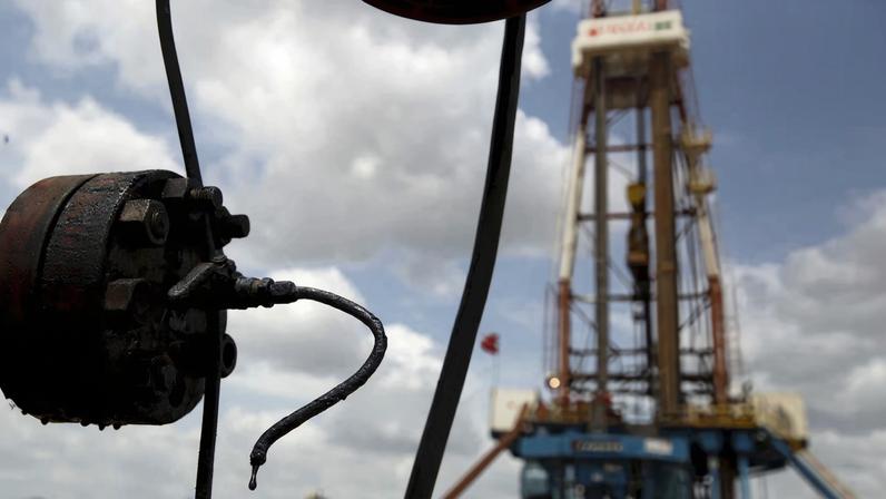 Crude oil drips from a valve at an oil well operated by Venezuela's state oil company PDVSA, in the oil rich Orinoco belt, near Morichal at the state of Monagas