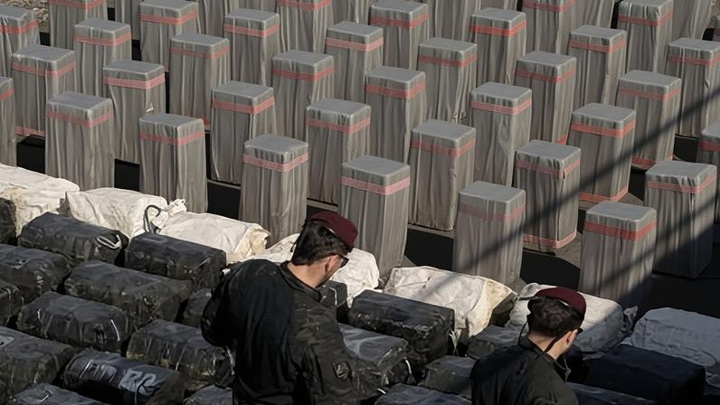 Spanish police officers inspect drug packages found in the cargo vessel that they seized.