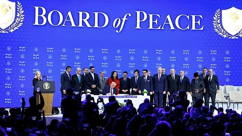 Donald Trump signs for the Gaza Peace Council at the World Economic Forum in Davos, Switzerland, on Thursday.