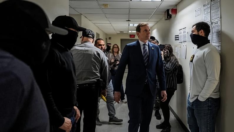 Representative Dan Goldman walks past federal immigration officers waiting for respondents to depart from their hearings to conduct targeted detainments at immigration court in New York on 23 October 2025.