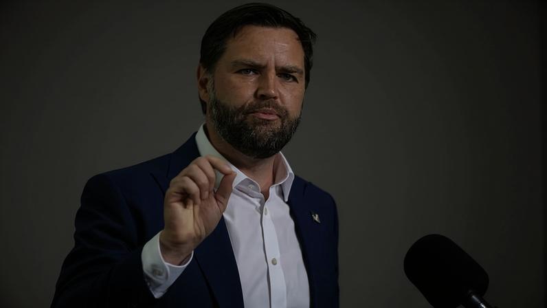 Vance gestures as he speaks