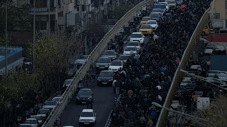 Protesters march on a bridge in Tehran, Iran. The IHR said Wednesday was the bloodiest day of the demonstrations with 13 protesters confirmed to have been killed.