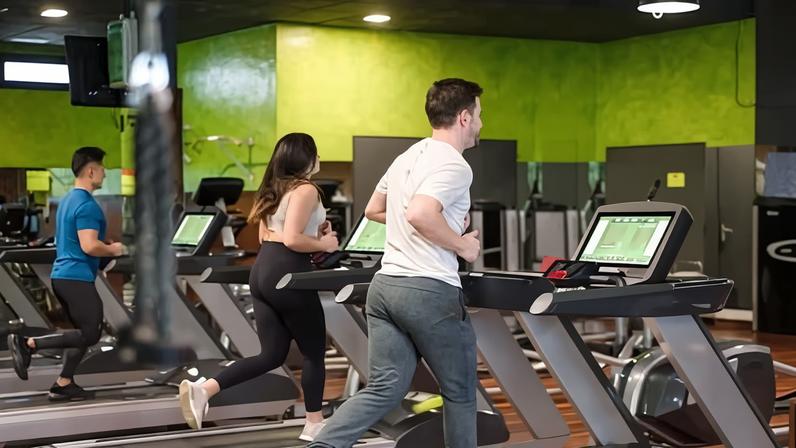 Group of people running on treadmills in modern sport gym