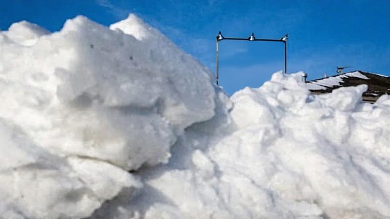 Snow piles up on the ground near a picture Donald Trump outside a home in West Des Moines, Iowa, on 3 February 2016.