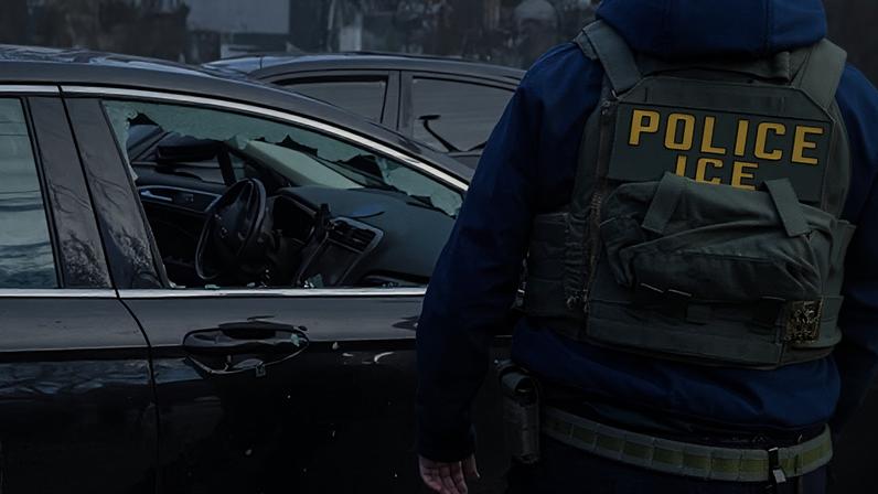 An ICE agent stands next to a car with a broken window after its driver was dragged away from the car by federal agents in Minneapolis, Minnesota, on 13 January 2026.
