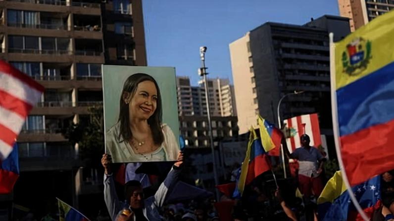 A person holds up an image depicting Venezuelan opposition leader María Corina Machado as people celebrate in Chile.