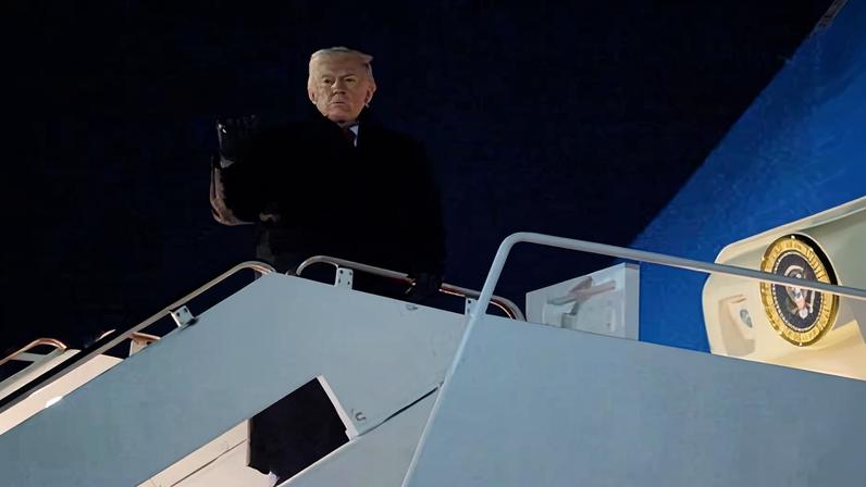 Donald Trump gestures as he boards Air Force One.