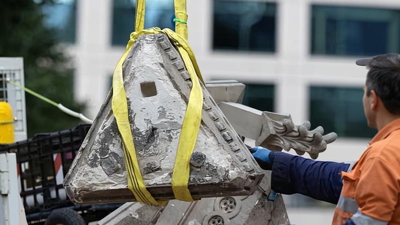 Workers removed the smashed Pioneer Monument in Flagstaff gardens in Melbourne.