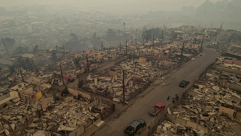 The remnants of burned out houses with air filled with smoke