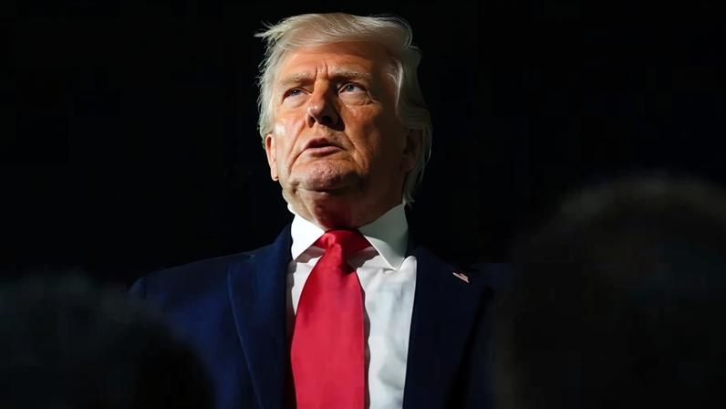 Donald Trump talks to reporters at Palm Beach international airport on Monday. He flew back to Washington DC in the early hours before getting ready to head to Davos.
