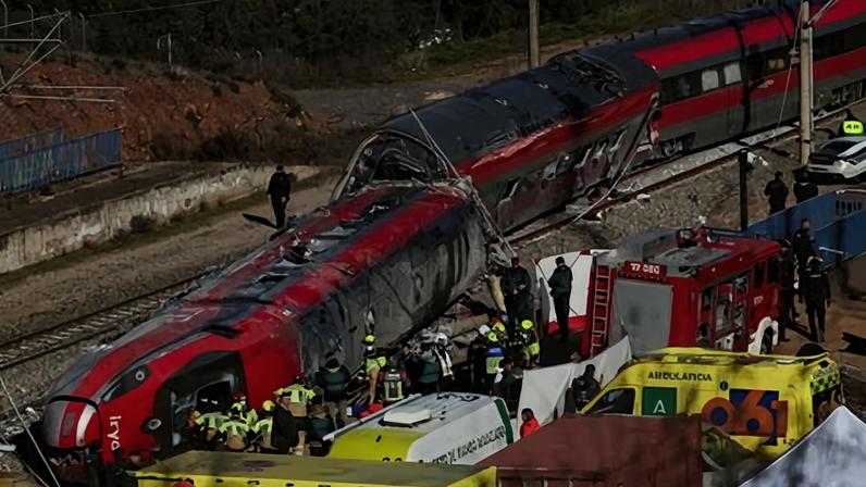Guardia Civil officers and other emergency personnel work next to one of the trains involved in the crash.