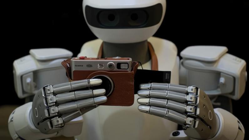 A Sharpa North robot uses a camera at CES 2026 in Las Vegas.