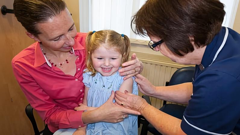 A child receives her second dose of the MMR vaccination. Experts described the WHO’s decision as a wake-up call.