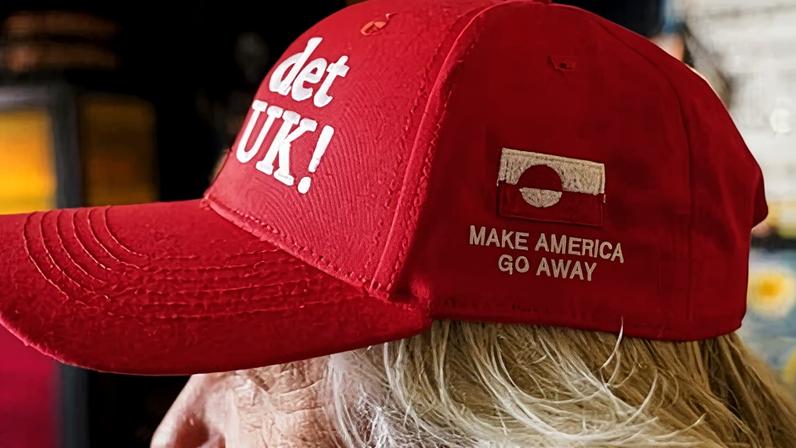 Store owner Jesper Rabe Tonnesen wears a red cap for sale that he created with the slogans Make America Go Away, on the side, and on the front: ‘Nu det NUUK!’, a twist on the Danish phrase ‘Nu det nok,’ meaning ‘Now it’s enough.’ Photograph: James Brooks/AP