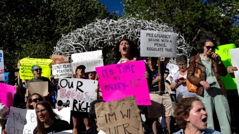 Abortion rights protesters chant slogans during a gathering to protest the supreme court's decision in the Dobbs v Jackson Women's Health case on 24 June 2022 in Jackson Hole, Wyoming.