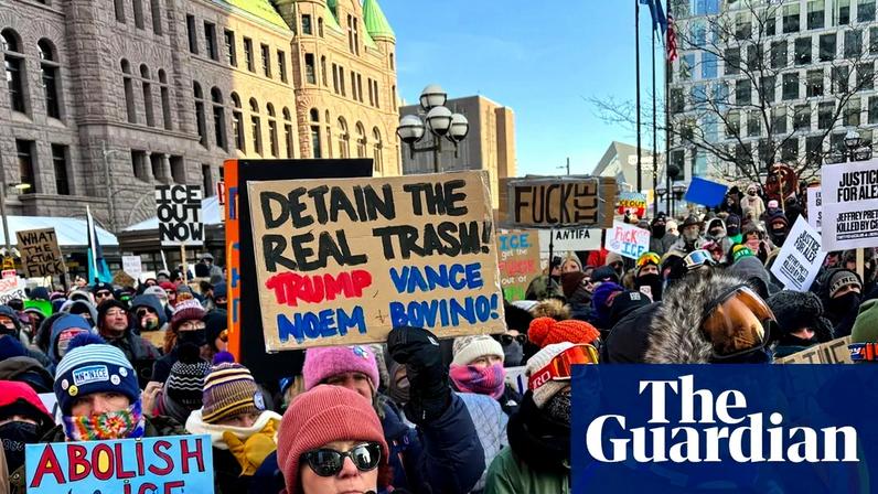 People hold aloft banners at an anti-ICE rally in Minneapolis on Sunday. One reads: 'It was murder'