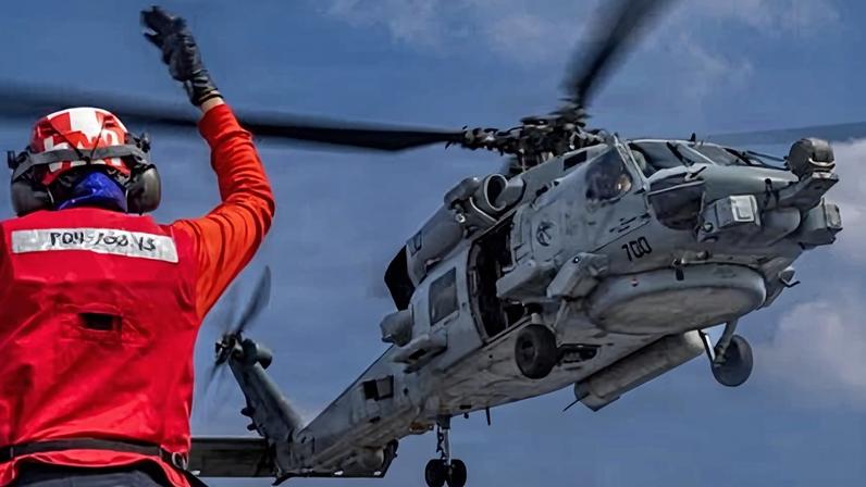 An MH-60R Sea Hawk helicopter on the flight deck of the Nimitz-class aircraft carrier USS Abraham Lincoln in the Indian Ocean on 21 January.