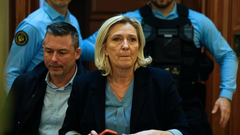 Marine Le Pen leaves a hearing during her appeal against her conviction for embezzlement of European parliament funds in Paris on Tuesday.