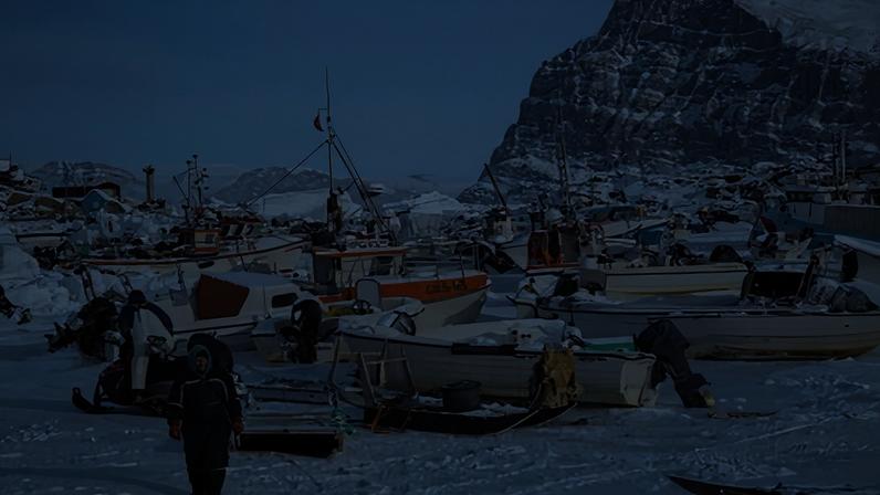 Fishers in a frozen harbour in Greenland.