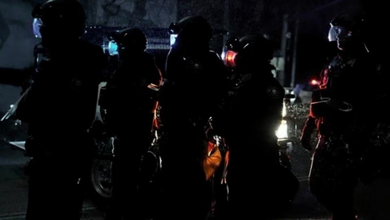 Portland police officers walk outside the ICE facility during a protest in Oregon on 8 January 2026.