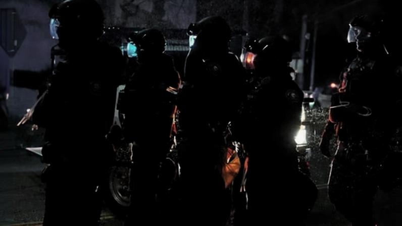 Portland police officers walk outside the ICE facility during a protest in Oregon on 8 January 2026.