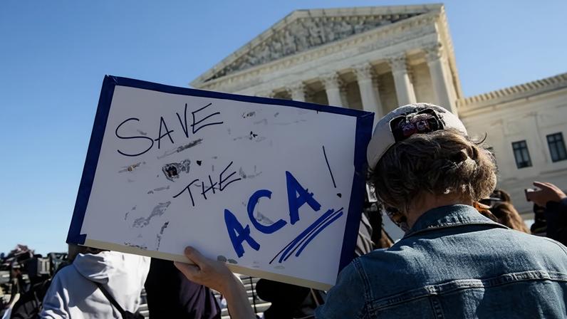 A demonstrator holds a sign in front of the US supreme court in Washington DC on 10 November 2020.